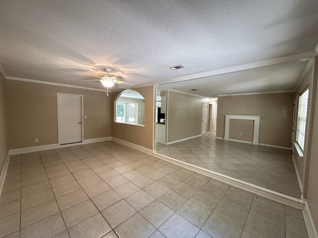 6842 Tomy Lee Trl, Tallahassee, FL 32309 - empty room featuring ornamental molding, light tile patterned floors, ceiling fan, a textured ceiling, and baseboards