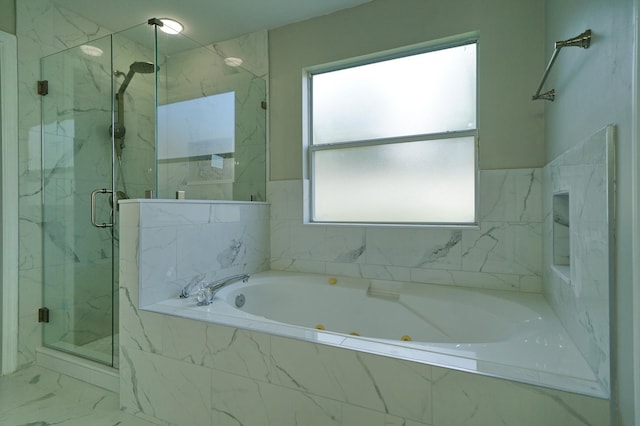 bathroom featuring separate shower and tub