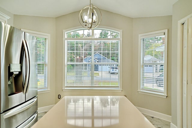 dining area with an inviting chandelier