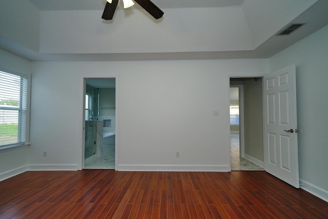 unfurnished bedroom featuring dark hardwood / wood-style floors, ceiling fan, and ensuite bathroom