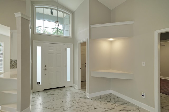 foyer with high vaulted ceiling