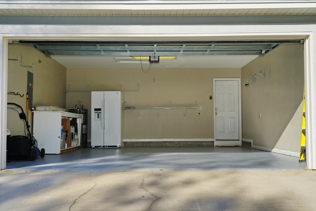 garage featuring white fridge with ice dispenser