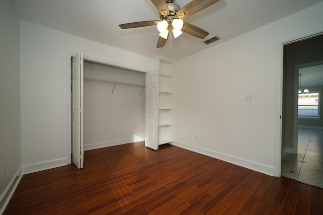 unfurnished bedroom with dark hardwood / wood-style floors, ceiling fan, and a closet