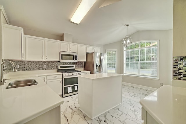 kitchen featuring sink, a center island, pendant lighting, vaulted ceiling, and appliances with stainless steel finishes