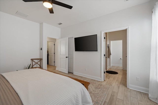 bedroom featuring visible vents, a ceiling fan, light wood-type flooring, and baseboards