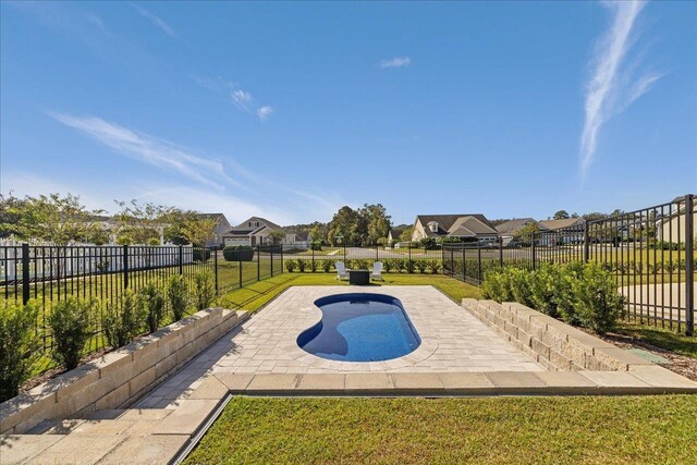 view of pool featuring a lawn, a patio, a fenced backyard, and a fenced in pool