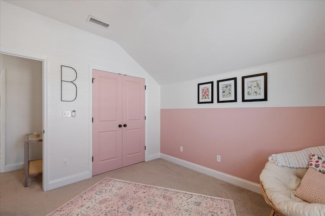living area with vaulted ceiling, baseboards, visible vents, and light carpet