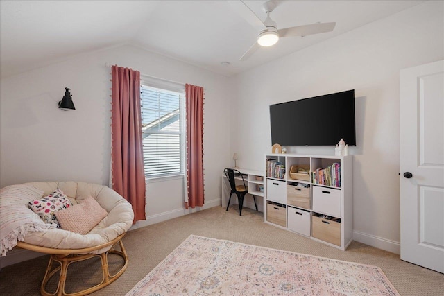 living area featuring lofted ceiling, light carpet, baseboards, and ceiling fan
