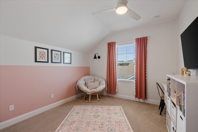 sitting room with vaulted ceiling, a ceiling fan, light colored carpet, and baseboards
