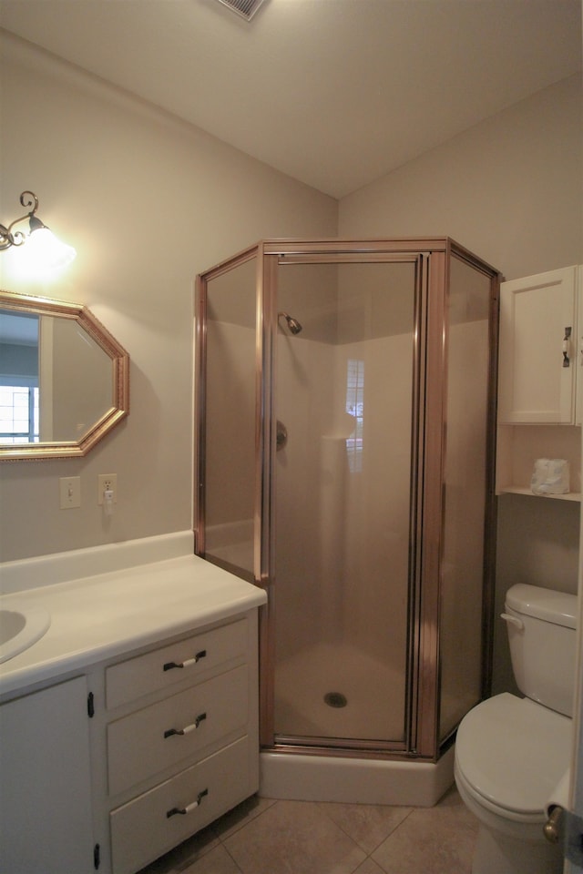 bathroom with toilet, vanity, tile patterned flooring, and a shower with door