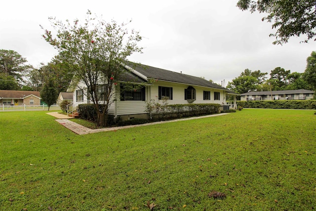 rear view of house with a lawn