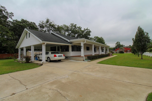 view of front facade featuring a carport, a front yard, and covered porch