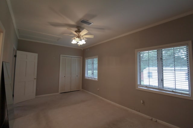 unfurnished bedroom with carpet flooring, multiple windows, ceiling fan, and a closet