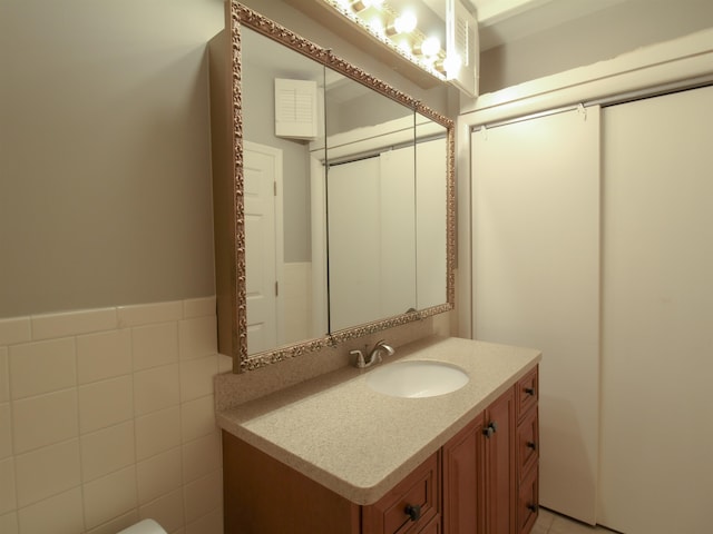 bathroom featuring tile walls and vanity