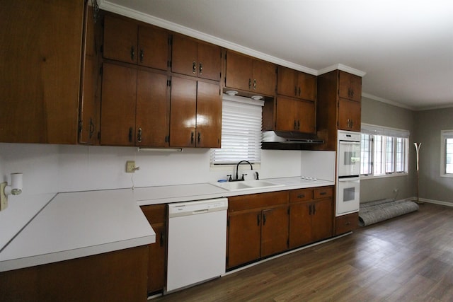 kitchen with white appliances, dark hardwood / wood-style floors, sink, and crown molding