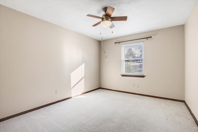 empty room featuring ceiling fan and light colored carpet