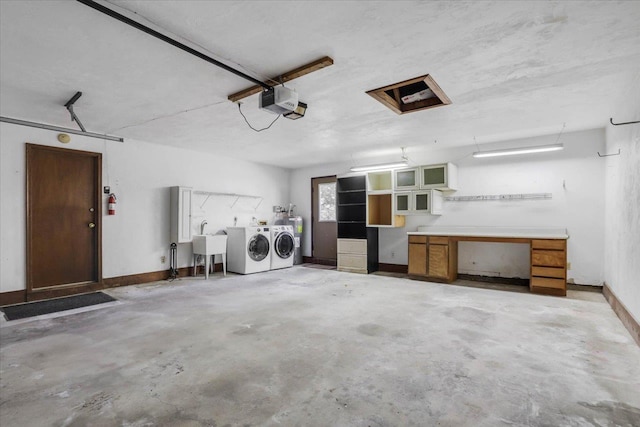 garage with sink, a garage door opener, and washing machine and clothes dryer