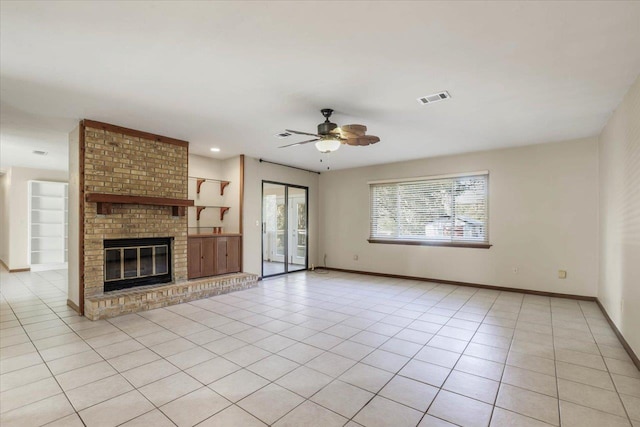 unfurnished living room featuring ceiling fan, light tile patterned floors, and a fireplace