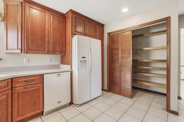 kitchen with light tile patterned flooring and white appliances