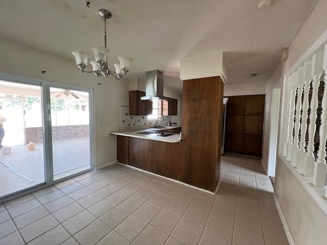 kitchen featuring decorative backsplash, ventilation hood, an inviting chandelier, and light tile patterned floors