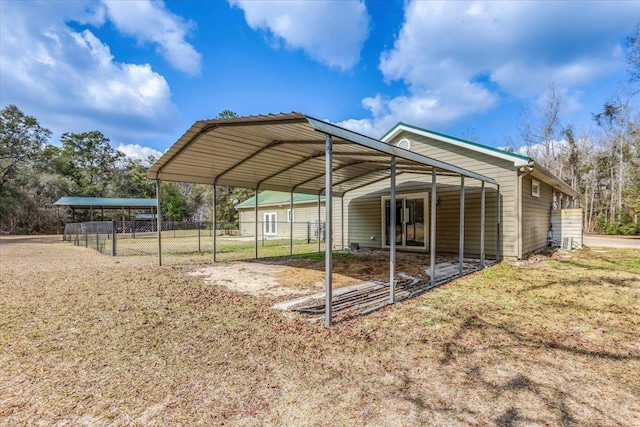 view of vehicle parking featuring a detached carport and fence