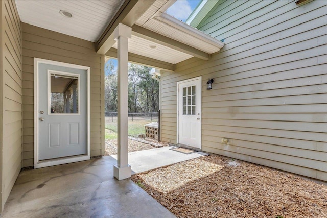 view of exterior entry with fence
