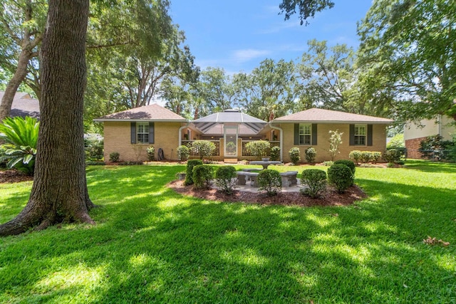 3219 Foley Dr, Tallahassee, FL 32309 - back of property featuring brick siding and a lawn