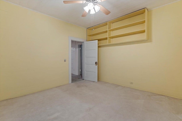 empty room with ceiling fan and light colored carpet