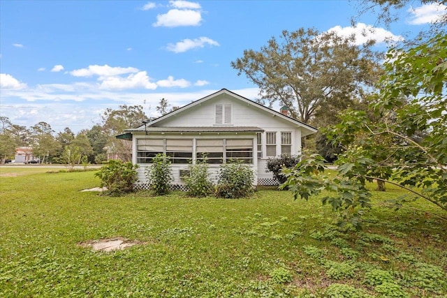 view of home's exterior with a yard