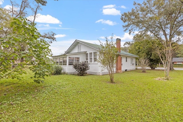 view of side of property featuring a yard