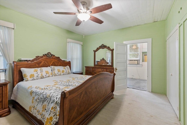 carpeted bedroom featuring ceiling fan and cooling unit