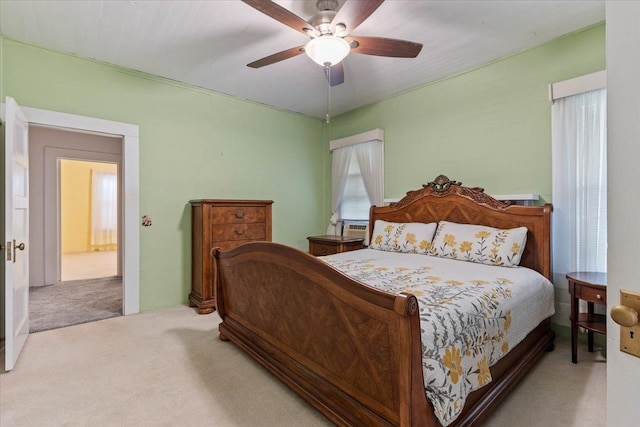 bedroom with ceiling fan and light colored carpet