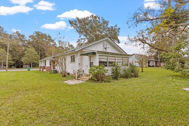 rear view of property featuring a yard