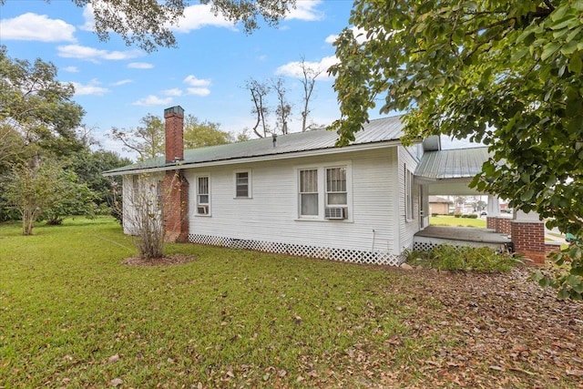 view of home's exterior featuring cooling unit and a lawn