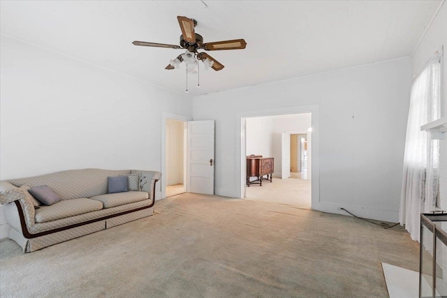 carpeted living room with ceiling fan