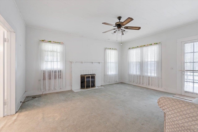 unfurnished living room featuring ceiling fan, a healthy amount of sunlight, and light carpet