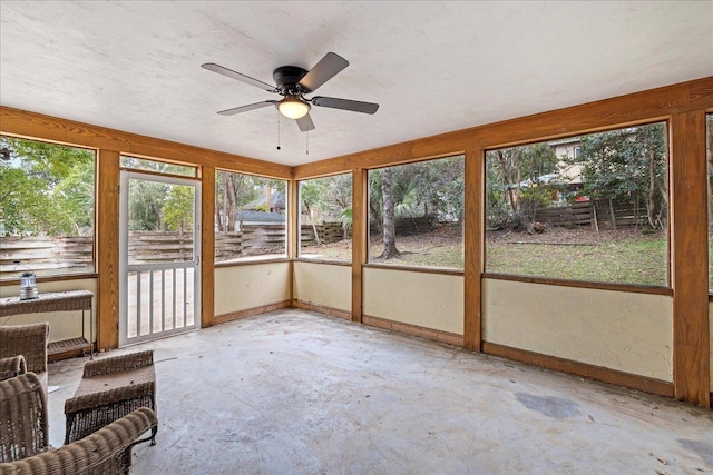 unfurnished sunroom with ceiling fan