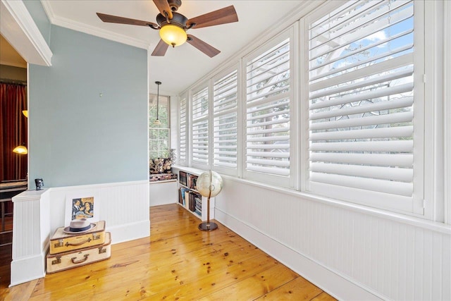 sunroom / solarium featuring ceiling fan