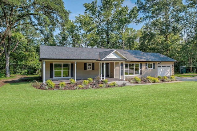 single story home featuring covered porch, a front yard, and a garage