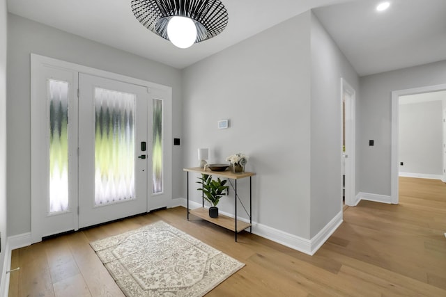 foyer entrance with light hardwood / wood-style floors