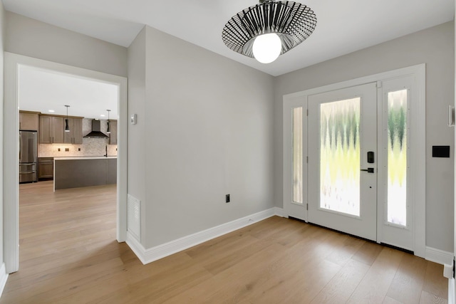 foyer entrance with light hardwood / wood-style floors