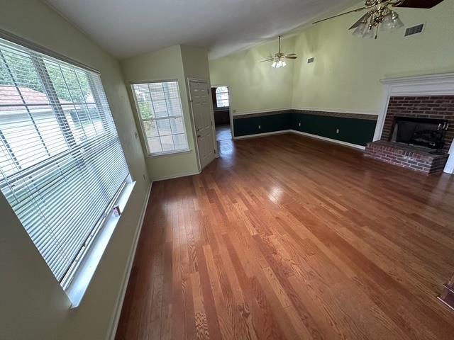 5356 Tewkesbury Trce, Tallahassee, FL 32309 - unfurnished living room with ceiling fan, wood finished floors, and a brick fireplace
