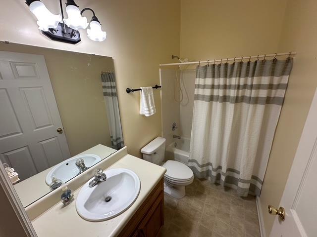 5356 Tewkesbury Trce, Tallahassee, FL 32309 - bathroom featuring vanity, a chandelier, toilet, shower / tub combo with curtain, and tile patterned floors