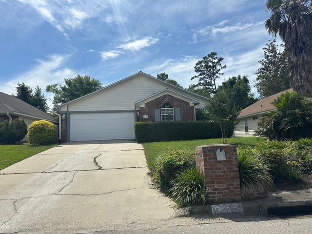 5356 Tewkesbury Trce, Tallahassee, FL 32309 - ranch-style house featuring concrete driveway, a garage, brick siding, and a front lawn