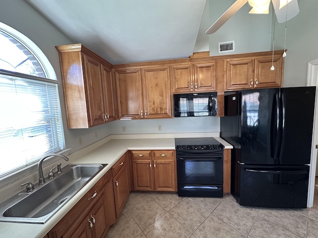 5356 Tewkesbury Trce, Tallahassee, FL 32309 - kitchen with black appliances, a sink, brown cabinets, light tile patterned floors, and light countertops