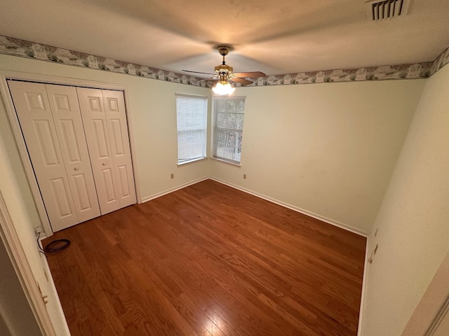 5356 Tewkesbury Trce, Tallahassee, FL 32309 - unfurnished bedroom with dark wood finished floors, baseboards, a ceiling fan, and a closet