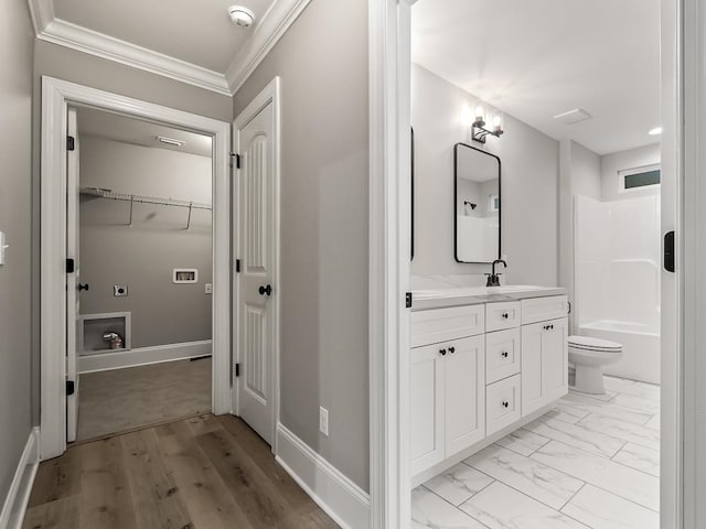 full bathroom with tub / shower combination, vanity, toilet, and ornamental molding