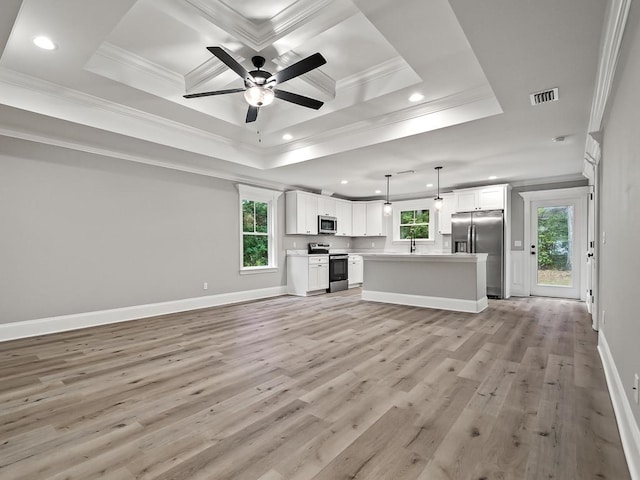 kitchen with white cabinetry, stainless steel appliances, light hardwood / wood-style flooring, decorative light fixtures, and ornamental molding