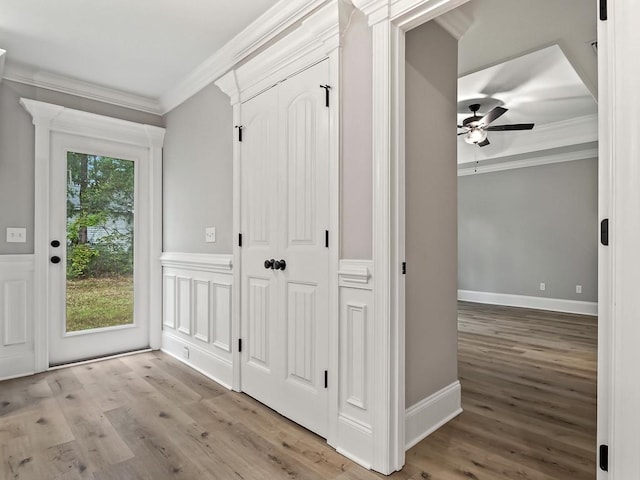 interior space with light hardwood / wood-style flooring and ornamental molding