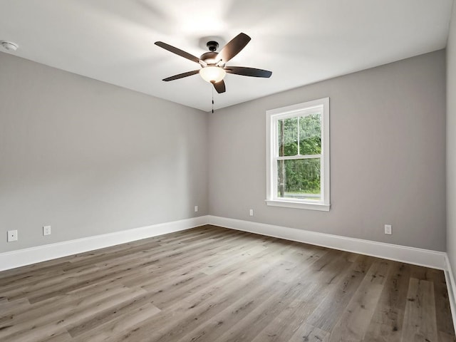 empty room featuring wood-type flooring and ceiling fan